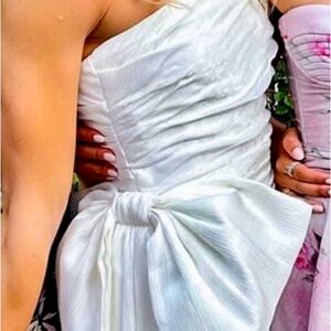 White dress with bow detail on side.  Originally size 4. Altered down size 0/2